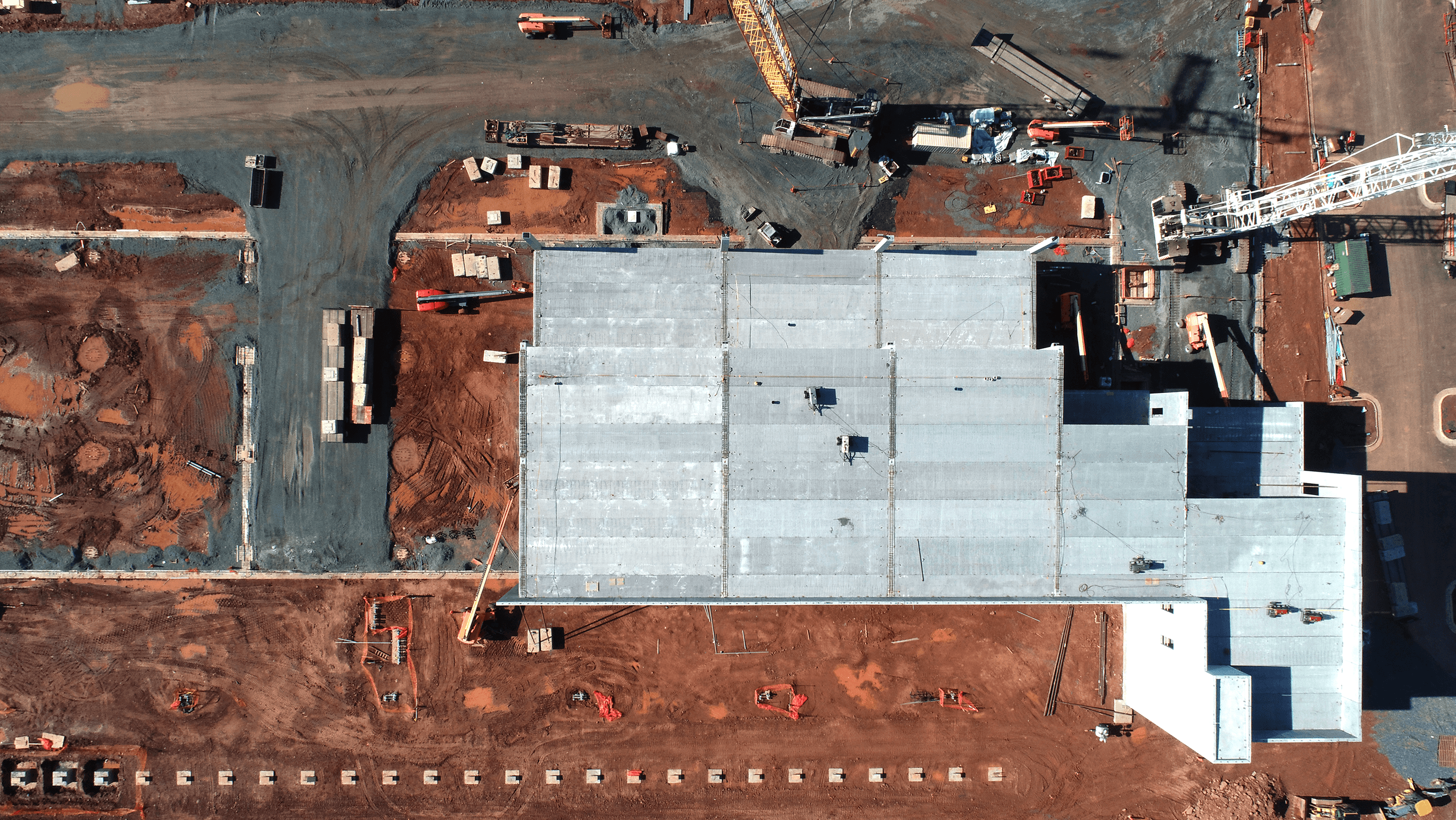 Overhead aerial view of building foundation and cranes